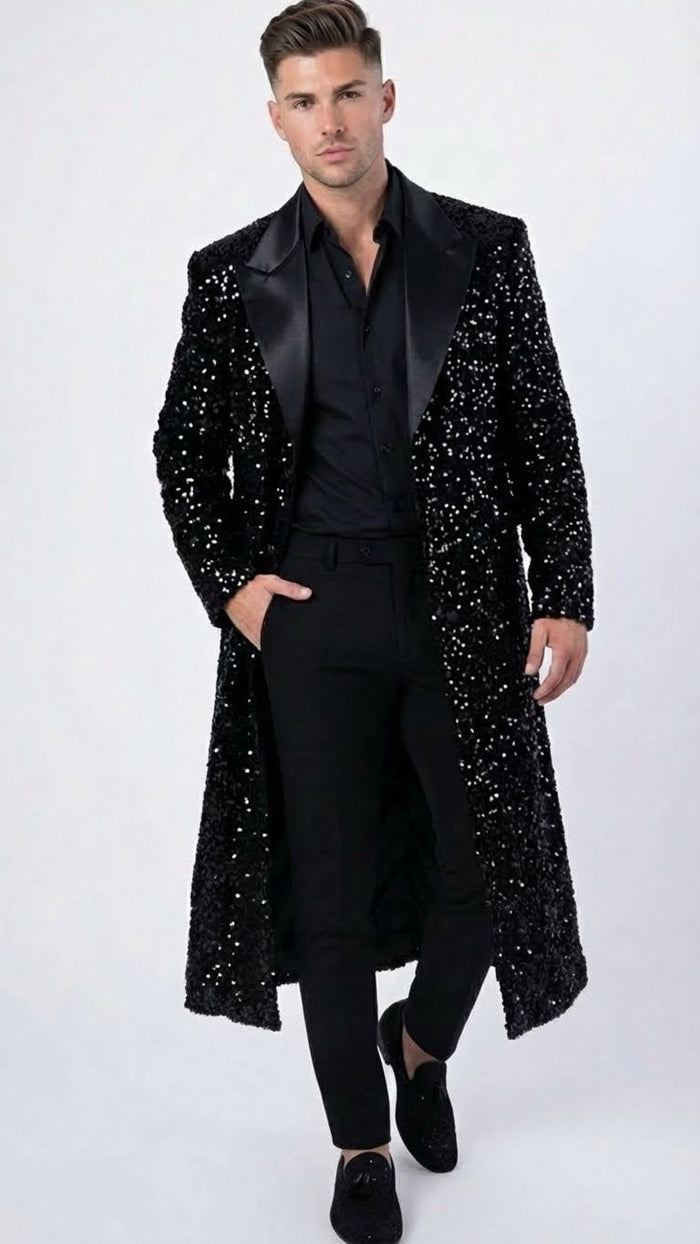 Men's black sequin long coat with satin shawl lapel, mid-calf length. Shiny black sequins create a reflective texture. Black lining completes the formal look.

