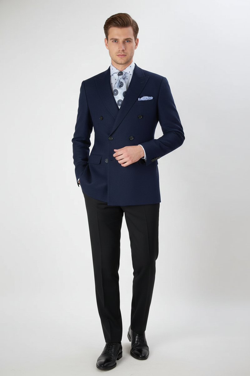 Navy double-breasted men's blazer. Structured, fitted shape with notched lapels and textured fabric. Features double-breasted buttons and a breast pocket. Deep navy color.
