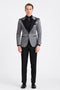 Silver metallic tuxedo with black satin peak lapel and vertical jacket stripes. Single black button, waist notch. Includes black trousers and shirt.
