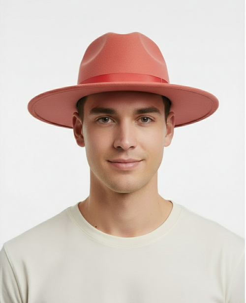 Men's coral pink fedora hat with a wide brim and flat crown. Crafted from wool felt, it features a red ribbon band. Perfect for a stylish statement.
