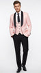 Men's blush pink tuxedo suit: jacket w/ black shawl lapel, structured shoulders, textured fabric. Includes matching vest & black dress pants. Single-breasted, button closure, pockets.
