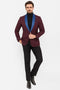 Burgundy men's tuxedo blazer with blue satin peak lapels. Single-button closure, fitted shape, and buttoned cuffs. Features a left chest pocket. Ideal for formal events.

