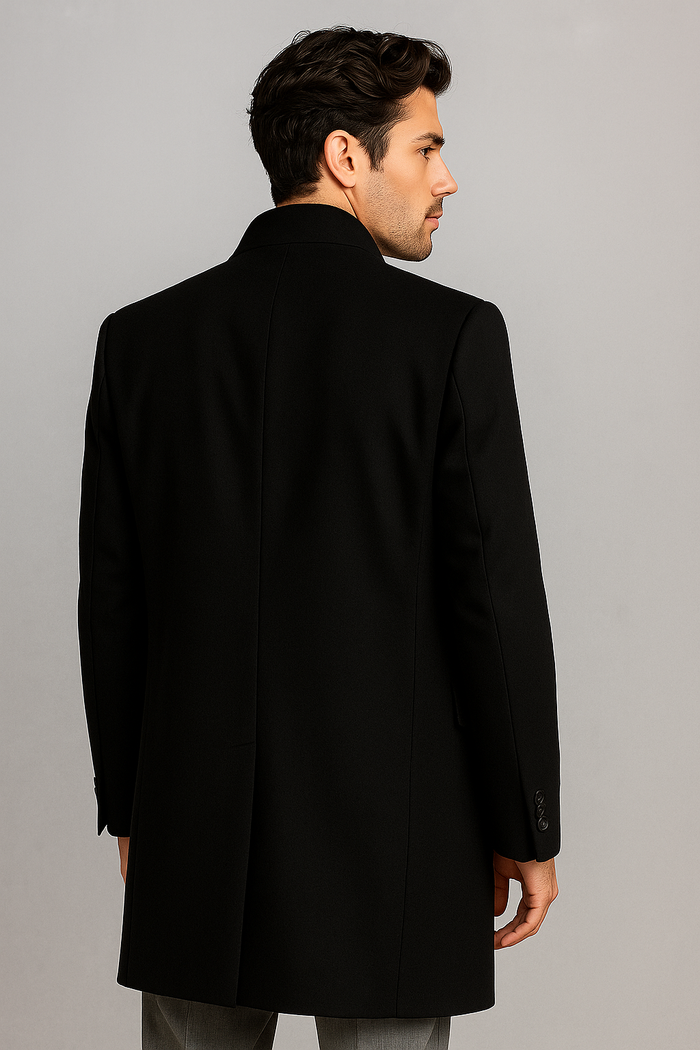 Alberto Nardoni men's black overcoat. Tailored straight cut with high collar & long sleeves. Wool/cashmere blend. Solid black, smooth texture, visible seams, button cuffs. Structured design.
