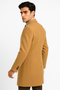 Men's camel wool & cashmere overcoat. Full-length, fitted, structured silhouette. Smooth texture, notched lapel, single-breasted button closure. Tailored seaming, fitted sleeves with cuff buttons. Formal design.
