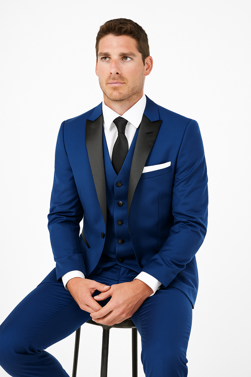Blue tuxedo: fitted, single-breasted, peak lapels, black satin. Includes waistcoat, matching buttons, white shirt, tailored blue trousers. Elegant formal wear.
