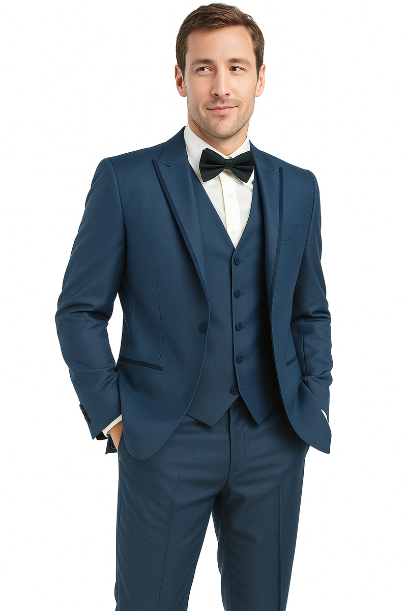 Blue sharkskin tuxedo: single-breasted jacket with peak lapels, slim-fit trousers. Features a finely textured surface and smooth finish. Includes satin bow tie and white dress shirt. Tailored for a structured look.
