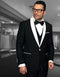 Black wool tuxedo with white shawl lapel, trims, and buttons. Fitted silhouette. Smooth wool blend. Vested design. Classic formal look.

