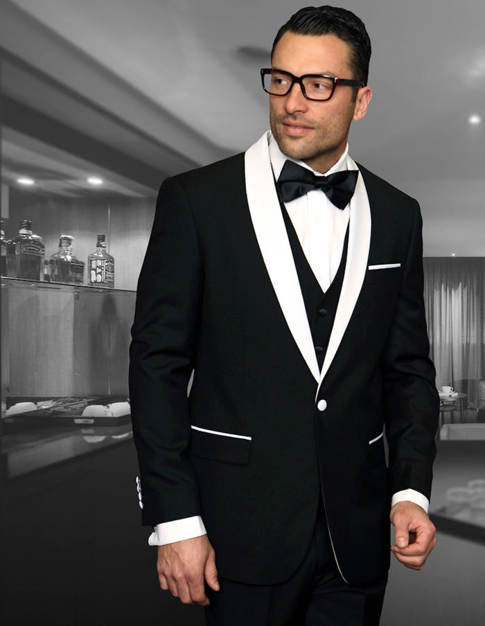 Black wool tuxedo with white shawl lapel, trims, and buttons. Fitted silhouette. Smooth wool blend. Vested design. Classic formal look.

