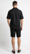 Men's black walking suit featuring a short-sleeved shirt and matching shorts. The shirt has a relaxed fit with a classic collar, and the shorts are tailored with a rolled cuff. Both pieces are made of a lightweight, textured fabric that appears breathable.