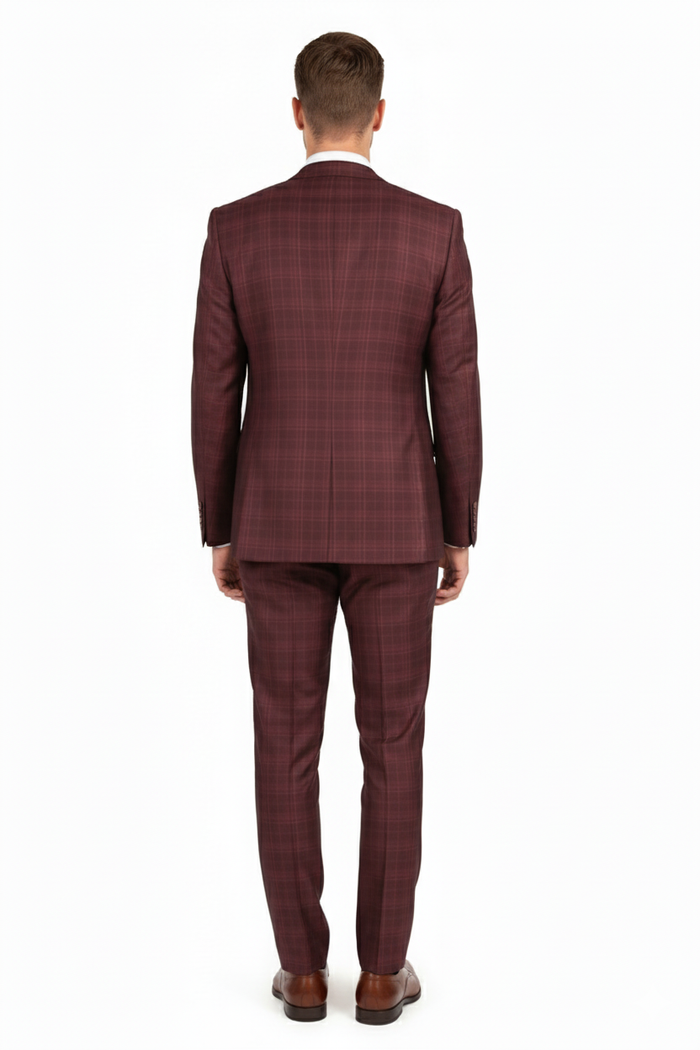 Men's burgundy three-piece suit: fitted blazer, vest, and pants. Windowpane plaid pattern in varying burgundy shades. Classic fit, textured fabric, single-vent blazer. Tailored pants.
