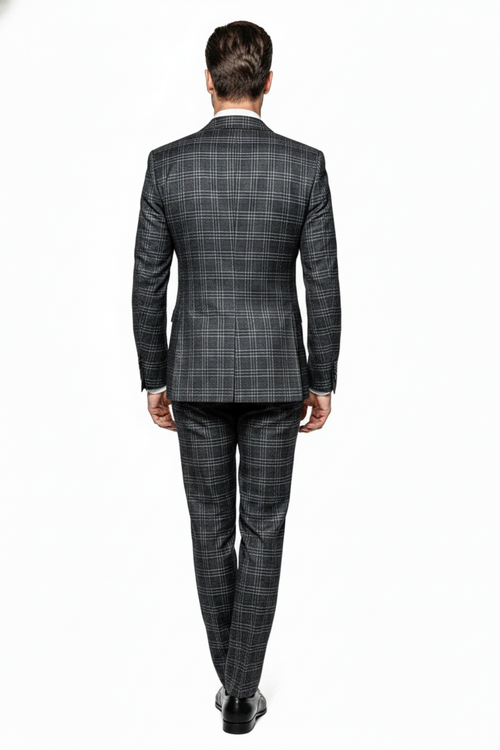 Charcoal plaid double-breasted suit: structured blazer with notched collar, two rows of buttons, and matching tailored trousers. Dark charcoal base with light gray plaid. Sleek silhouette.
