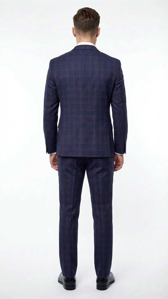 Navy & burgundy checkered two-piece suit: fitted blazer & matching trousers with plaid windowpane pattern. Tailored seams, structured silhouette, smooth fabric (wool-like). Trousers taper to ankles.
