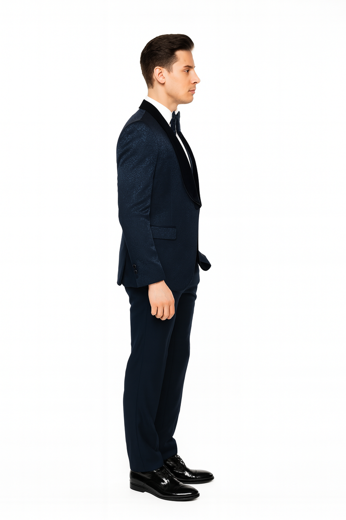 Navy jacquard tuxedo for men. Black velvet shawl lapel, tailored fit. Textured jacket paired with solid navy trousers. Classic, elegant design.
