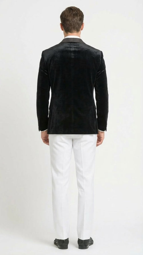 Black velvet tuxedo blazer with studded lapel. Fitted design, soft & shiny fabric. Features visible lapel detailing, single back vent, and structured shoulders for a tailored fit.
