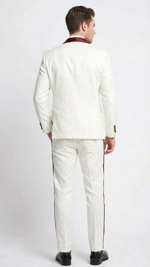 Ivory jacquard tuxedo suit with burgundy accents. Textured ivory jacket and matching tailored trousers. Fitted jacket with smooth back and streamlined trousers. Ideal for formal events.
