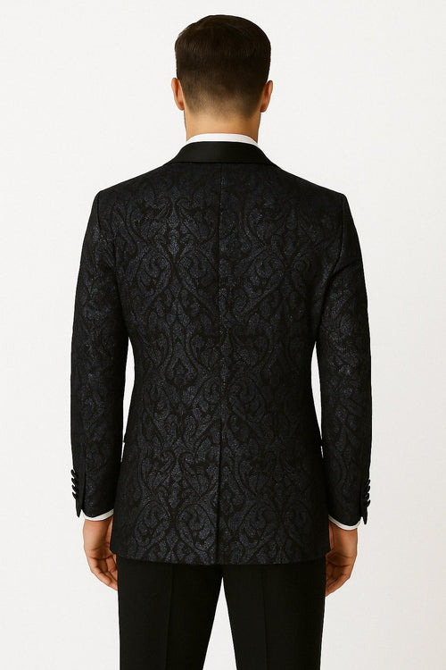 Navy & black glitter floral tuxedo jacket with satin lapel. Sequin fabric, intricate floral pattern. Tailored lines & structured shoulders for a sleek silhouette.
