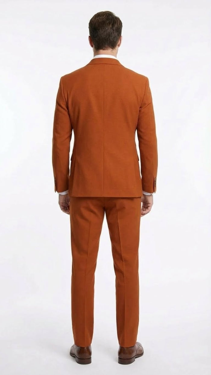 This product is a burnt orange double-breasted suit made of a textured material. The jacket features a straight back with defined shoulder seams. The trousers have a tailored fit, tapering at the ankles.