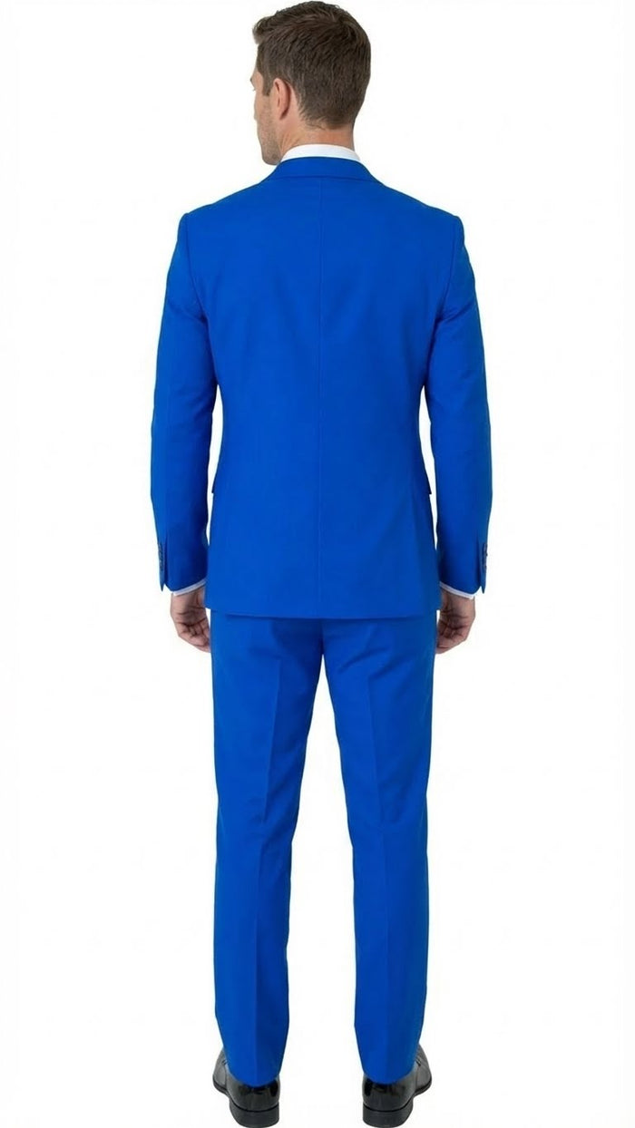 Royal blue men's tuxedo suit with embellishments, structured fit, and single vent. Includes matching tailored trousers. Lapel details enhance the design. Paired with a contrasting white shirt (collar visible).
