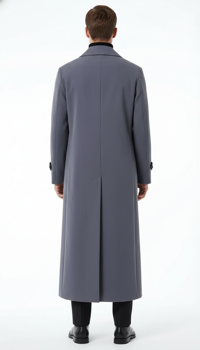 Men's charcoal grey overcoat. Full-length, straight silhouette with long sleeves, tailored collar, and central back vent. Smooth, uniform fabric. Button cuffs. Falls below the knee.
