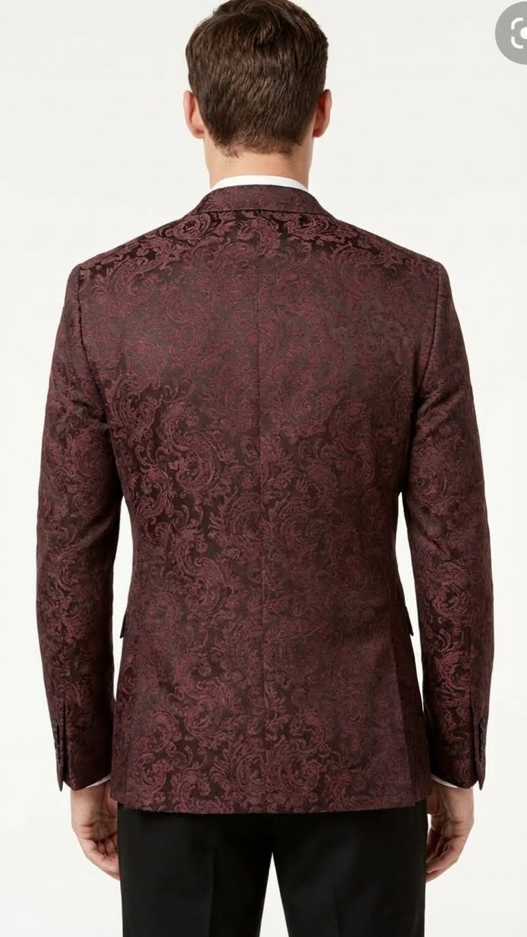 Burgundy paisley velvet blazer. Structured fit, single vent. Floral pattern, tailored sleeves with button cuffs. Formal, detailed design.
