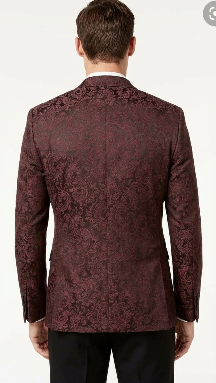 Burgundy paisley velvet blazer. Structured fit, single vent. Floral pattern, tailored sleeves with button cuffs. Formal, detailed design.
