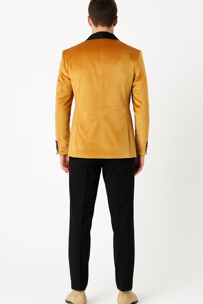 Mustard gold velvet tuxedo jacket for men. Smooth, lustrous texture with a single black collar. Fitted shoulders, tailored silhouette, and streamlined back. Rich golden hue.
