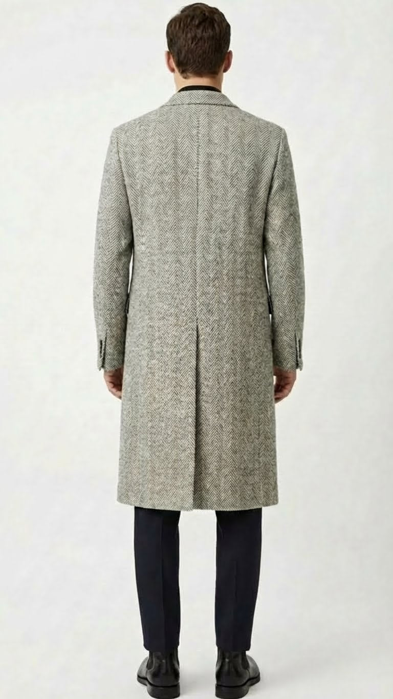 Men's grey herringbone overcoat: tailored fit, straight silhouette, mid-length. Textured fabric with grey herringbone pattern. Notched collar, buttoned cuffs, single back vent. Classic, clean design.
