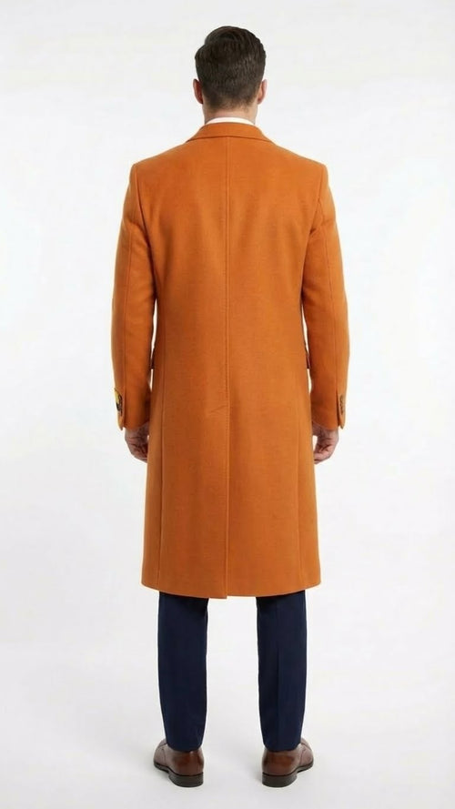 Alberto Nardoni men's long overcoat in orange rust wool blend. Tailored, straight cut extending below the knees. Soft, textured fabric. Classic collar, single back vent, buttoned cuffs. Solid color.

