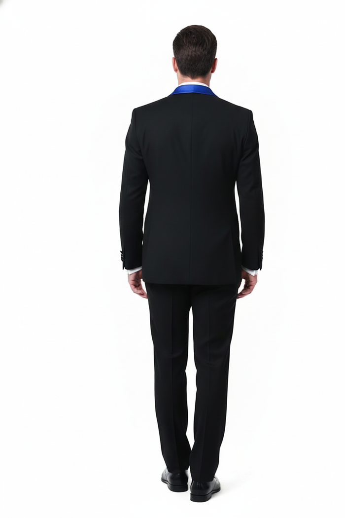 Men's black tuxedo with royal blue shawl lapel. Tailored fit, structured form, and smooth black fabric. Features buttoned sleeves & straight-leg trousers.
