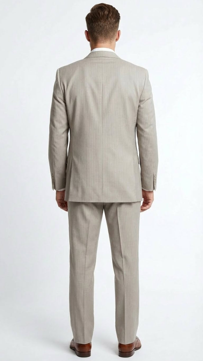 Men's light tan pinstripe three-piece suit (jacket, vest, pants). Tailored fit, subtle pinstripes, and structured fabric. Uniform tan color. Brown shoes complete the look.
