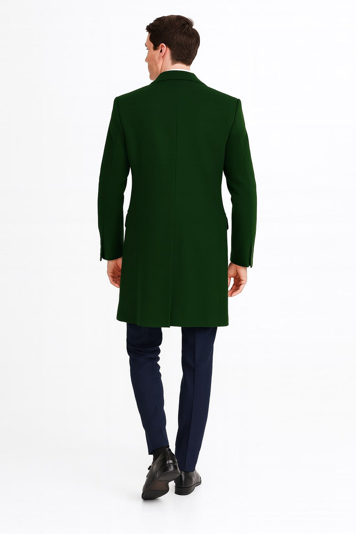 Dark green wool overcoat with a long, tailored silhouette. Features a notched collar, button closures, and single back vent. Solid color, smooth fabric. Versatile for formal and casual wear, extending to mid-thigh.
