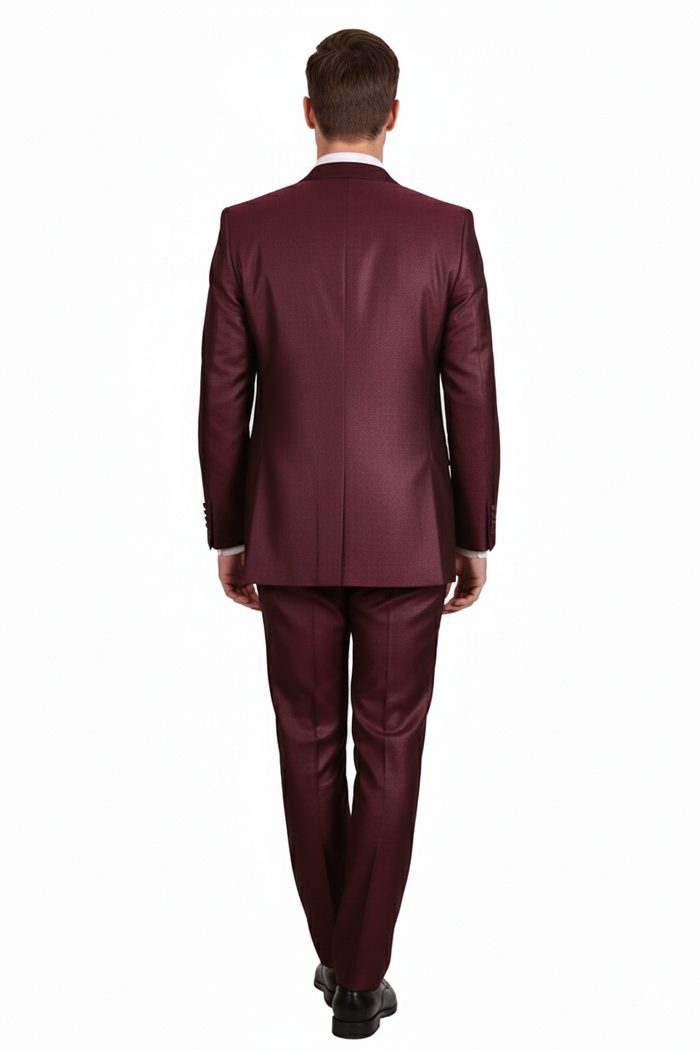 Men's burgundy three-piece suit: tailored fit, structured blazer, waistcoat, trousers. Rich color, subtle sheen. Smooth fabric, standard lapels, detailed stitching, straight-leg trousers.
