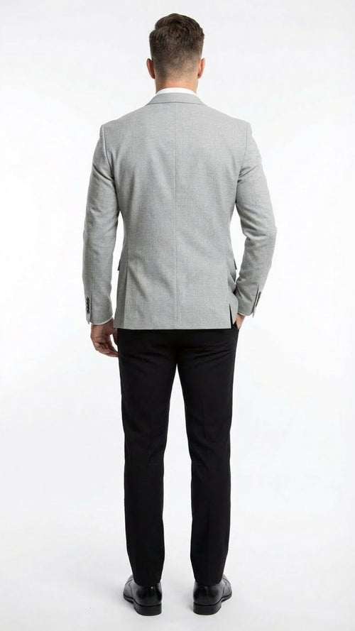 Men's light grey slim-fit blazer with a structured form, single back vent. Paired with straight-leg, solid black pants. Smooth blazer fabric with subtle texture.
