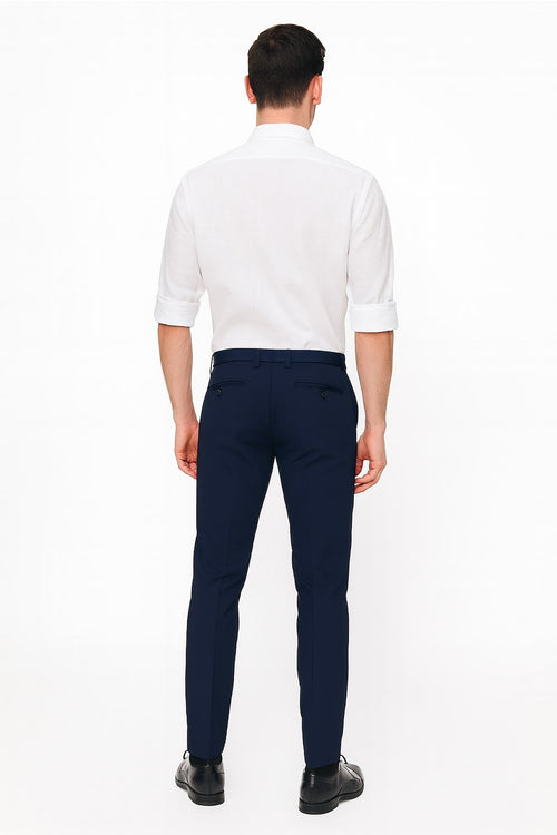 Men's white linen button-down shirt. Long sleeves with rolled cuffs, standard collar, and a straight cut. Lightweight, breathable fabric in solid white.
