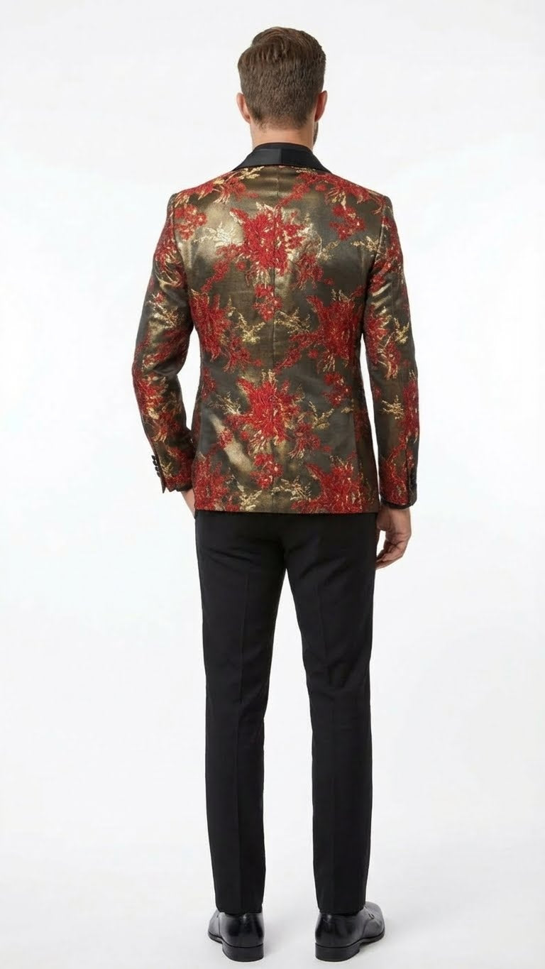 Men's red & gold paisley shawl lapel blazer. Fitted, tailored silhouette. Textured, metallic dark gold fabric with large red florals. Shawl lapel detail. Worn with black pants.
