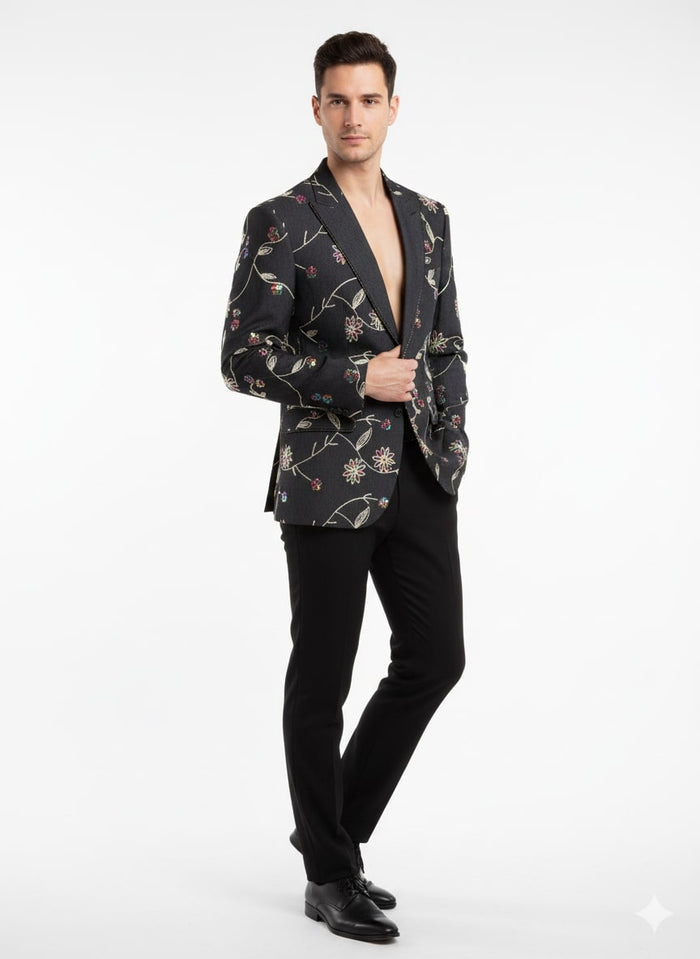 Men's black blazer with floral embroidery. Tailored fit, single-button closure, peaked lapels. Intricate multi-colored floral pattern on black. Long sleeves, smooth lining, hip-length. Perfect for formal events.
