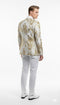Men's white & gold floral tuxedo jacket. Fitted silhouette, satin lapel. Intricate gold floral pattern on white. Smooth back, structured design. Long sleeves.
