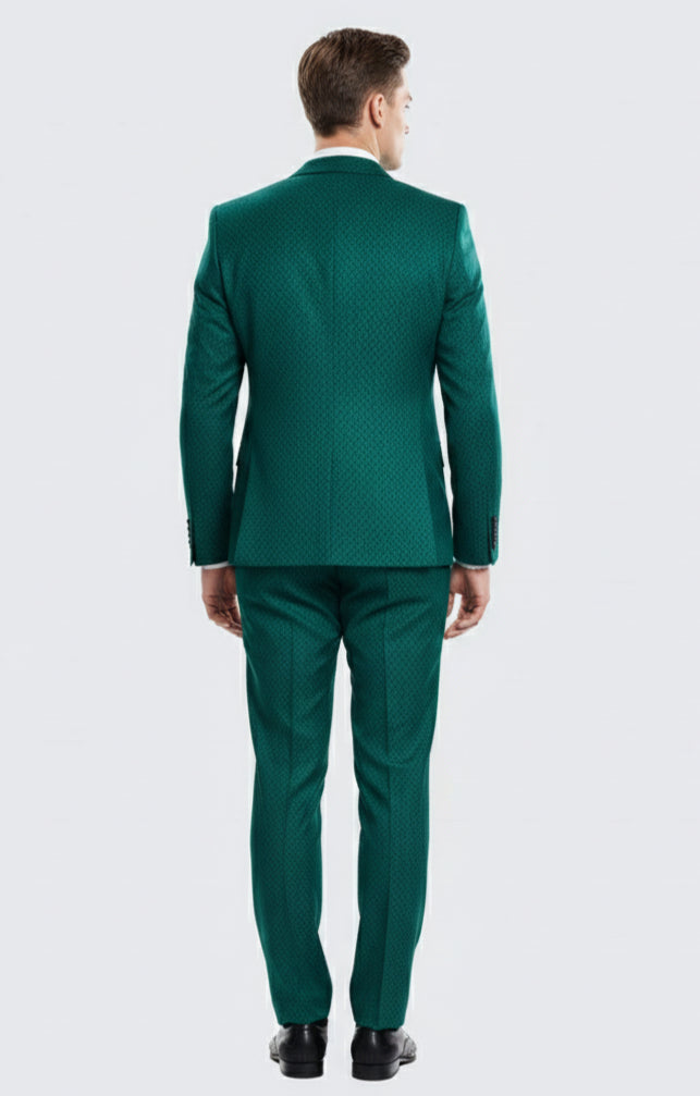 Men's emerald green three-piece suit. Textured fabric, tailored jacket with structured shoulders, tapered trousers, and matching vest. Sleek silhouette with consistent, rich emerald color.
