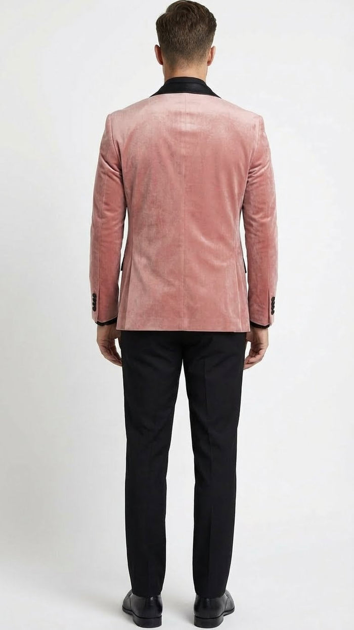 Men's dusty rose velvet blazer with black satin lapels. Structured fit, long sleeves, single back vent. Soft, textured fabric with a subtle sheen.
