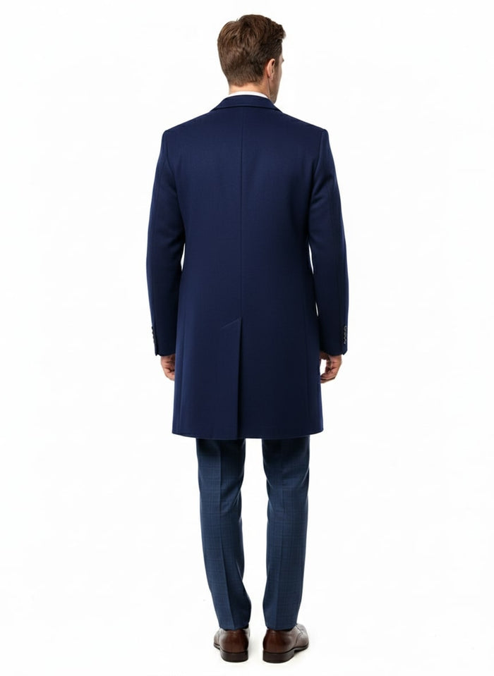 Men's cobalt blue wool/cashmere car coat. Long, tailored silhouette with single back vent. Structured shape, clean finish, smooth, rich blue fabric. Long, fitted sleeves with buttoned cuffs.
