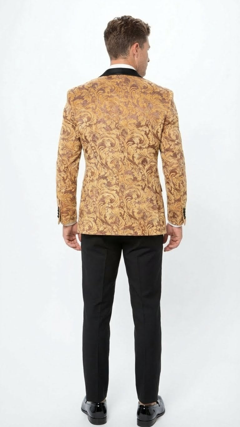 Yellow gold baroque tuxedo blazer. Fitted silhouette, two-button closure, notched lapels. Intricate gold and darker tone pattern. Paired with black trousers for contrast.

