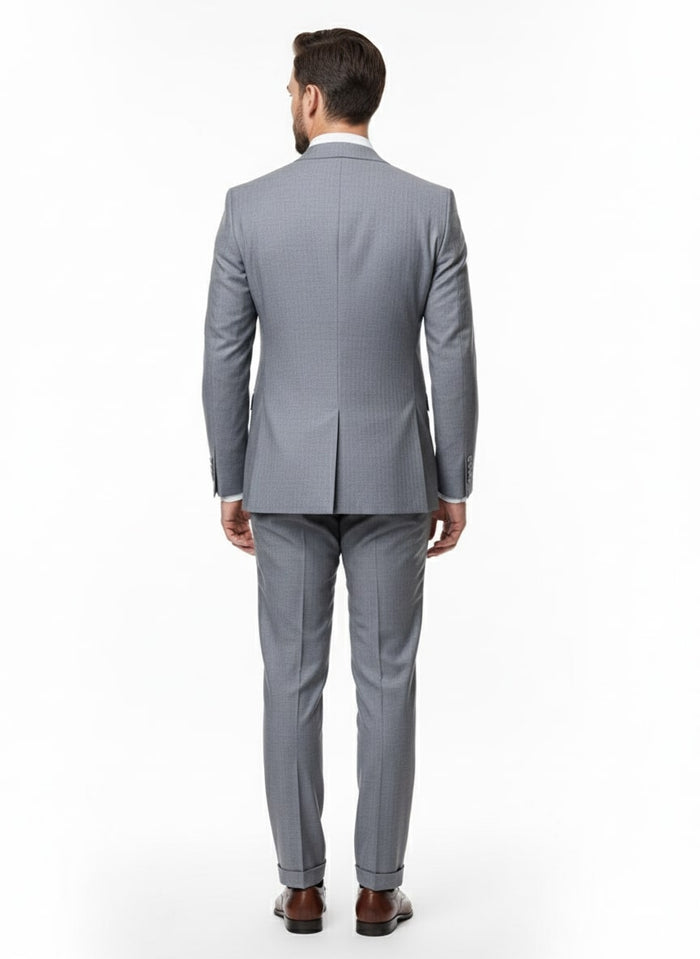 Men's grey tone-on-tone double-breasted suit. Slim fit, subtle shadow stripe. Structured jacket with center vent. Tailored trousers. Professional, cohesive grey look.
