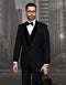 Elegant men's black wool tuxedo with velvet shawl lapel. Fitted silhouette, solid black, smooth texture. Includes vest, white shirt, and bow tie. Matching trousers complete the classic, pattern-free ensemble.
