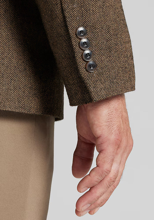 Alberto Nardoni's 1905 herringbone sportcoat. Brown herringbone with lighter threads. Tailored fit, structured, textured wool-like fabric. Features visible sleeve, four-button cuffs. Classic tailored look.