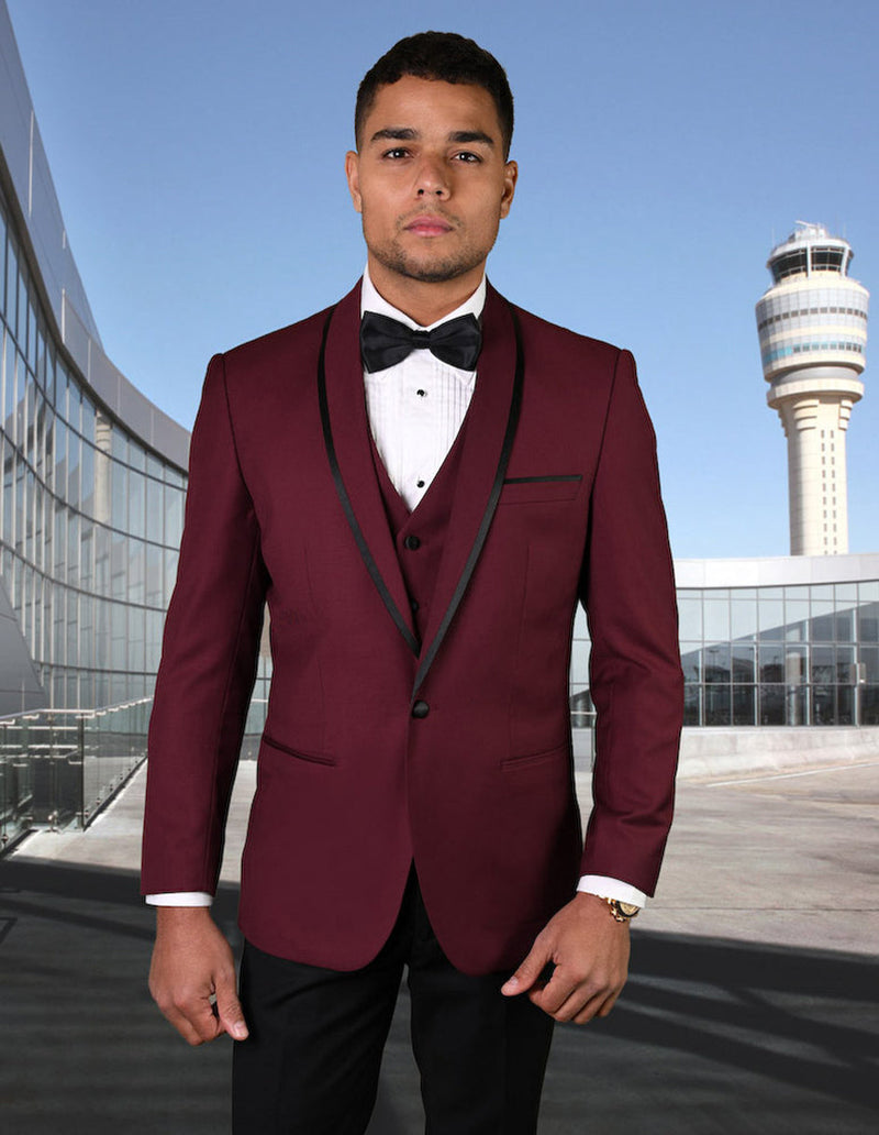 Burgundy wool tuxedo with shawl lapel and satin trim, black accents. Fitted, vested style with multiple buttons. Formal and elegant.

