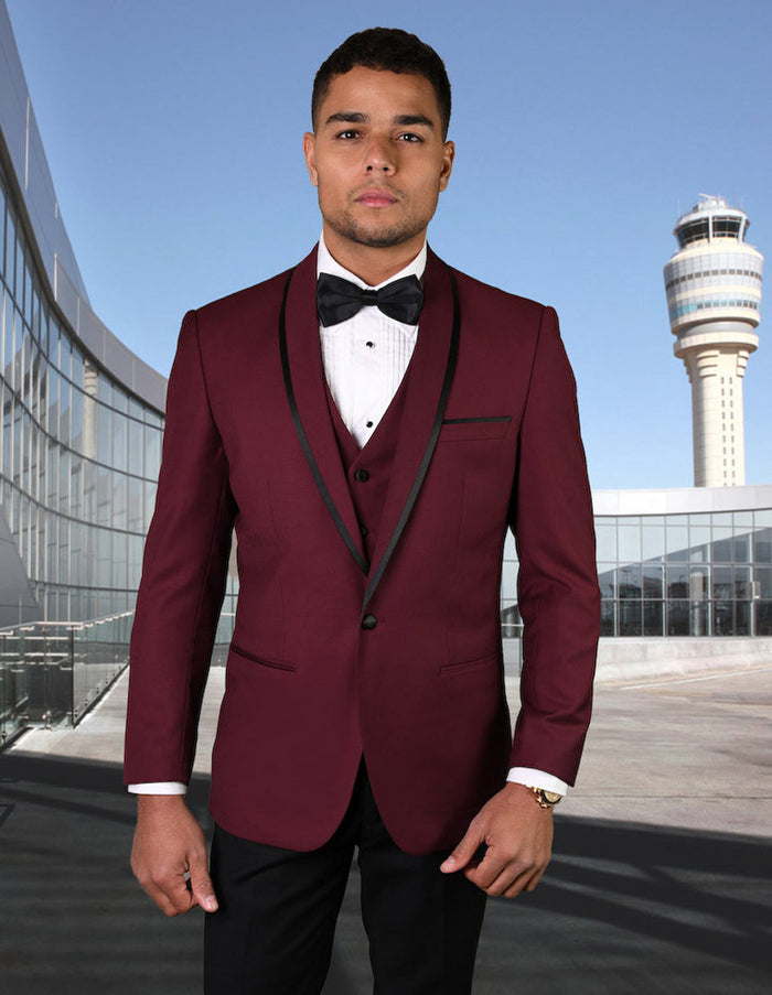 Burgundy wool tuxedo with shawl lapel and satin trim, black accents. Fitted, vested style with multiple buttons. Formal and elegant.
