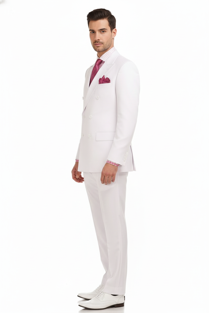 Men's white double-breasted suit: modern fit, jacket w/ buttons, matching trousers & waistcoat. Lightweight, smooth fabric. Pink checkered shirt, deep pink tie & pocket square. White brogue shoes.
