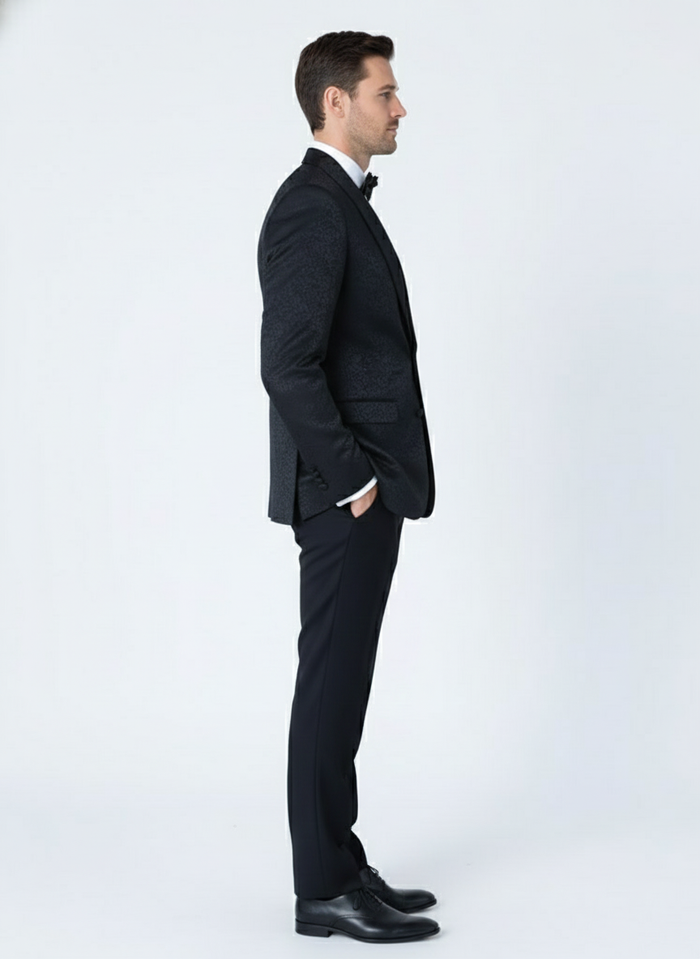 Men's black tuxedo suit: textured paisley jacket, flat-front trousers, and bow tie. Features an all-black floral paisley pattern, offering a sophisticated look.
