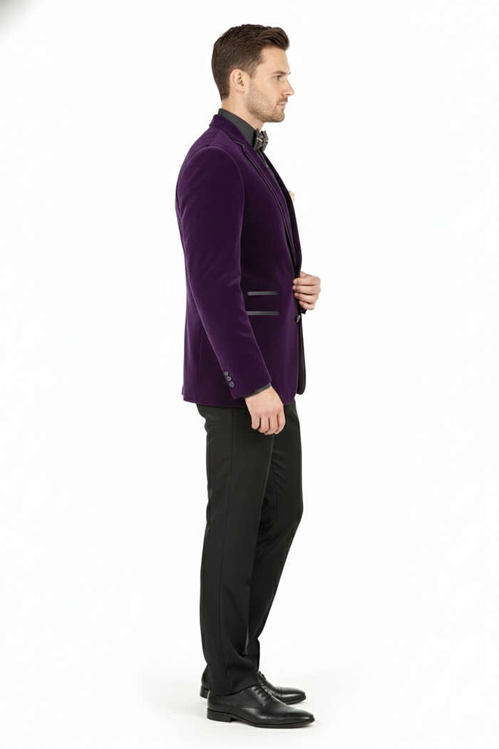 Men's slim-fit purple velvet blazer. Black lapel detail, buttoned cuffs, and two front pockets. Smooth, plush texture.
