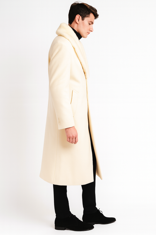 Men's ivory overcoat with faux fur shawl collar. Full-length, straight silhouette with side pockets and button details. Classic and elegant outerwear.
